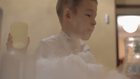 Child-is-happy-to-play-with-liquid-nitrogen-white-smoke