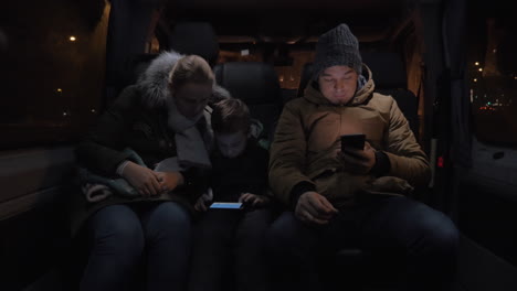 Passengers-in-minibus-passing-the-time-with-cellphones