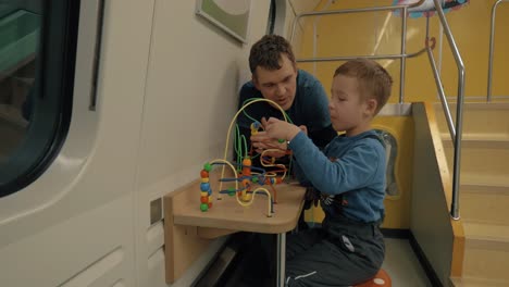 Dad-and-son-spending-time-in-train-play-room