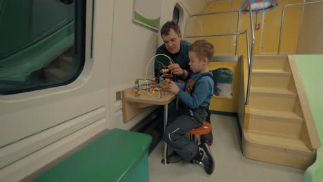 Father-and-child-in-train-play-space