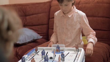 Girl-and-boy-playing-table-hockey-at-home