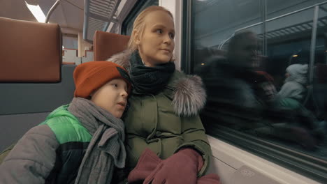 Mother-and-her-gentle-loving-son-traveling-by-train