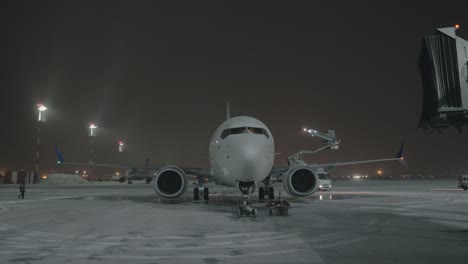 An-airplane-on-an-airport-courtyard-against-dark-sky