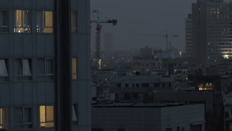 Evening-Tel-Aviv-view-with-houses-and-cranes-Israel