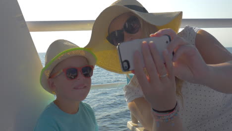 Mother-and-son-taking-selfie-during-sea-travel