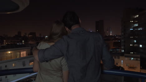 Looking-at-night-city-being-in-the-hugs-of-loving-man