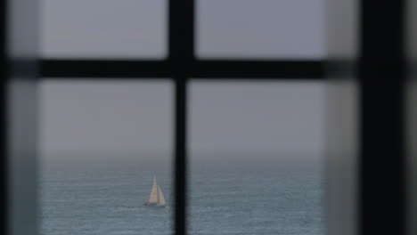 Sailboats-and-cutter-in-the-sea-view-through-the-window