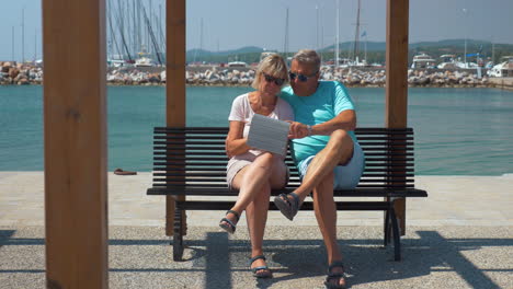 Senior-family-couple-with-pad-on-waterfront