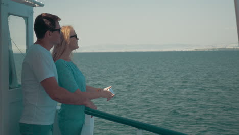 Loving-couple-making-mobile-selfie-during-sea-tour