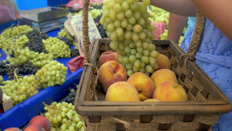 Woman-buying-grapes-and-peaches-on-market