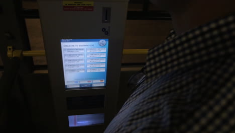 Man-taking-ticket-from-machine-in-the-bus