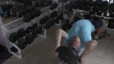Mature-man-exercising-with-weight-plate