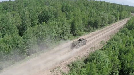 Flying-over-the-military-vehicle-driving-in-rough-wooded-country