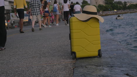 Suitcase-with-summer-on-hat-it-in-crowded-waterfront