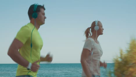 Young-sportive-couple-jogging-with-music