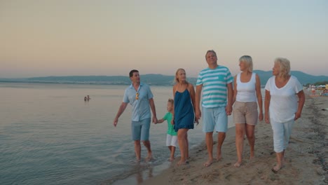 Big-family-walking-on-beach-and-taking-pictures