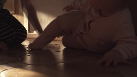 Crawling-baby-girl-and-big-brother-babysitting-her