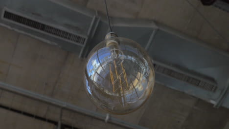 Glass-orb-lamp-hanging-in-the-ceiling
