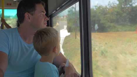 Father-and-little-son-traveling-by-bus