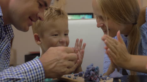Parents-and-child-playing-with-plasticine