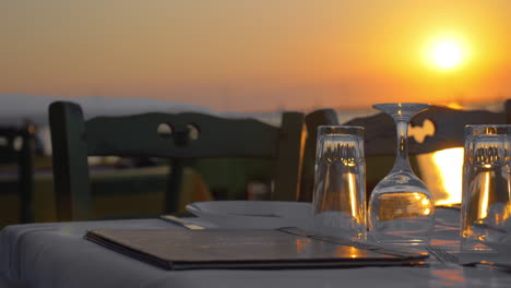 Served-table-in-outdoor-restaurant-at-sunset