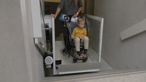 Woman-and-child-using-lift-for-carriages