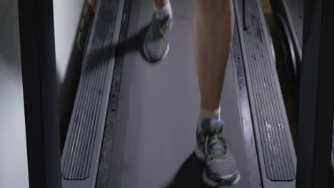 Adult-male-in-sneakers-walking-on-a-treadmill