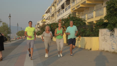 Young-and-senior-people-jogging-at-sunset