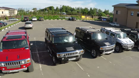 Flying-over-the-row-of-Hummer-cars-on-parking-lot