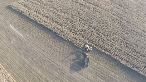 Farm-machinery-busy-with-crop-harvesting-aerial-view