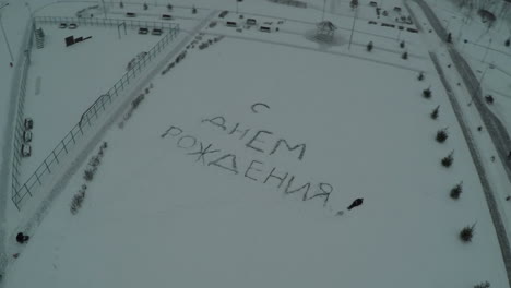 Flying-over-Happy-Birthday-text-on-the-snow
