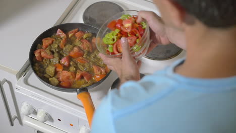 Man-Adding-Fresh-Pepper-into-the-Frying-Pan