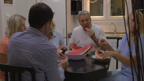 Big-family-eating-watermelon-in-the-kitchen