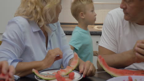 Grandma-feeding-grandchild-with-sweet-watermelon