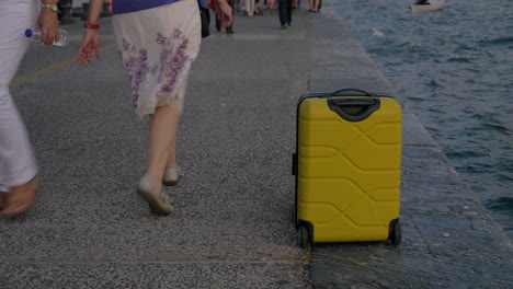 Suitcase-on-wheels-stands-on-promenade