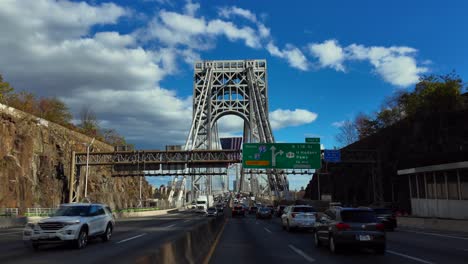 A-low-angle-view-driving-on-the-George-Washington-Bridge-from-New-Jersey-to-the-Bronx,-NY-on-a-sunny-day