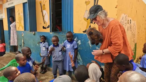 Fort-Portal,-Uganda,-Africa---24-August-2023:-Charity-volunteer-from-Australia-entertains-school-kids-in-Uganda-with-a-furry-wombat-puppet