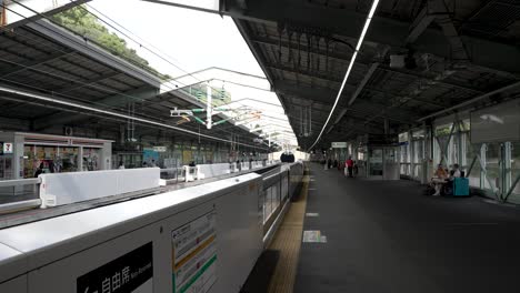 Static-shot-of-Shin-Kobe-public-Station-with-people-waiting-for-their-train-transport