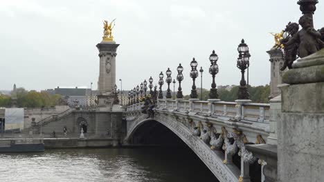 Pont-Alexandre-III-is-Beaux-Arts-style-bridge,-with-its-exuberant-Art-Nouveau-lamps,-cherubs,-nymphs-and-winged-horses-at-either-end