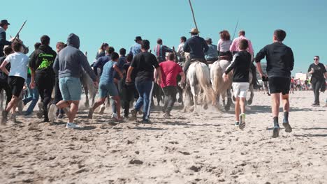 shot-of-young-children-chasing-the-horses-on-Palavas-beach-during-the-feria