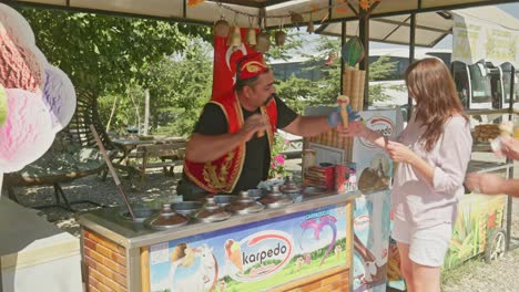 Turkish-ice-cream-vendor-playfully-teases-female-happy-customer