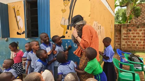Fort-Portal,-Uganda,-Africa---24-August-2023:-Charity-volunteer-shows-very-excited-school-kids-in-Uganda-a-wombat-puppet
