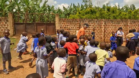 Fort-Portal,-Uganda,-Africa---24-August-2023:-Charity-volunteer-in-Uganda-entertains-kids-with-a-kangaroo-puppet-at-a-local-school-in-Gweri