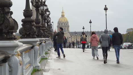 People-Cross-Pont-Alexandre-III-Bridge-with-Les-Invalides-in-Background