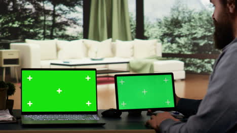 Entrepreneur-works-with-greenscreen-on-laptop-and-tablet
