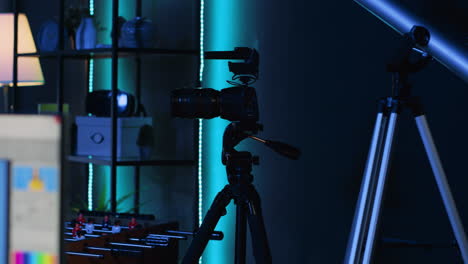Professional-camera-equipment-in-empty-blue-neon-lit-creative-photography-studio