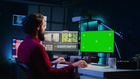 Video-editor-using-editing-software-on-green-screen-monitor-to-upgrade-footage-shot