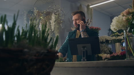 Female-Florist-Talks-By-Phone-with-Customer-and-Uses-Tablet
