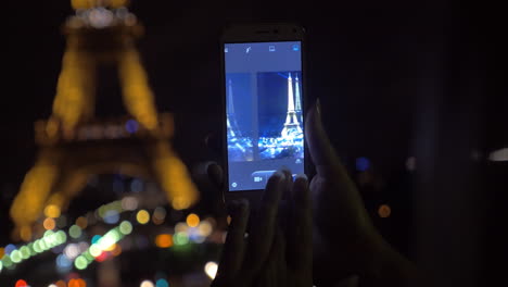 Mobile-shot-of-illuminated-Eiffel-Tower-at-night