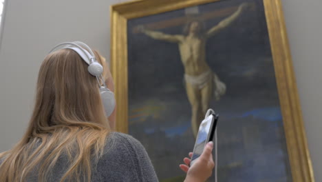 Woman-listening-to-audioguide-in-the-art-gallery